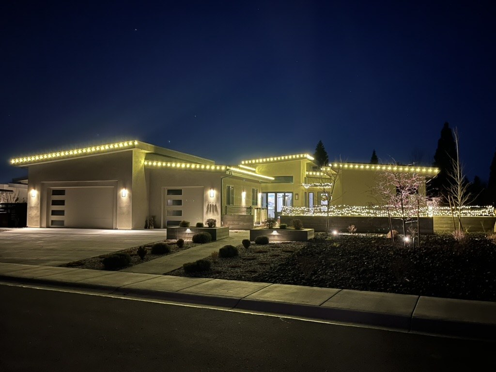 Modern single-story home with warm white roofline lighting